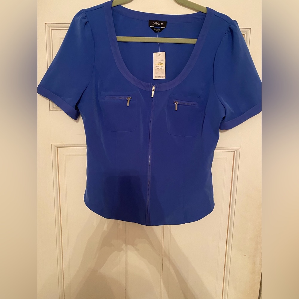 Bebe Blue zip up top. Brand new size M